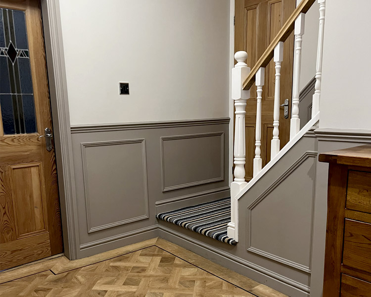 Wall panelling and stair bannister.