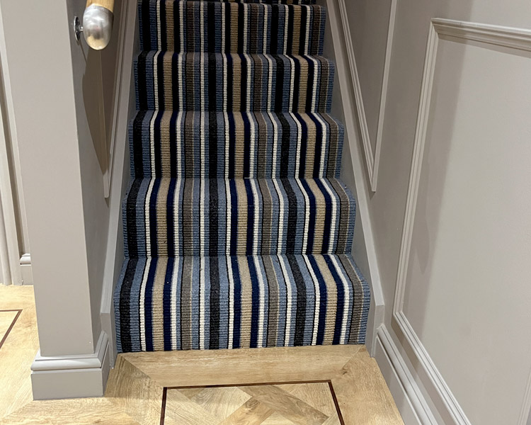 Stair carpet and wall panelling.