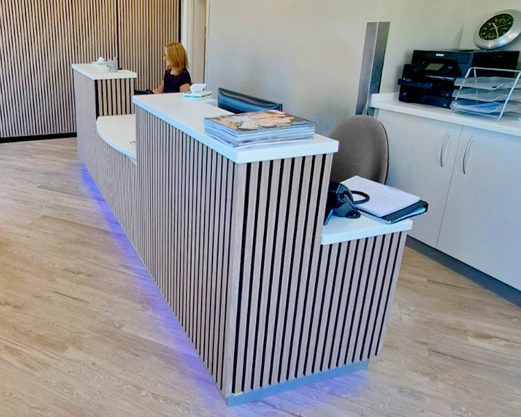 Contemporary slatted reception counter and feature wall.